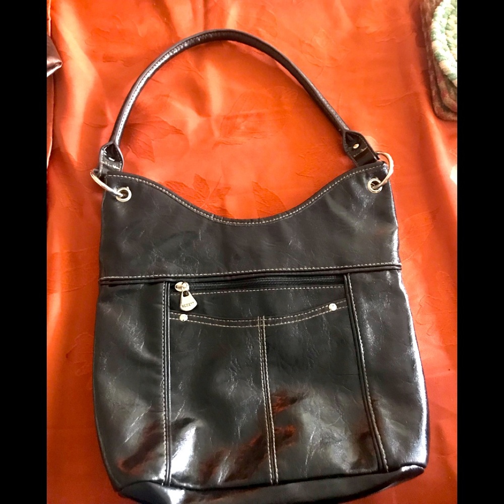 EUC Black Rossetti Bucket Bag. Silver Hardware. Full of zippers and pockets.